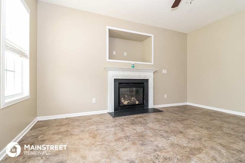 the living room has a fireplace and tile flooring