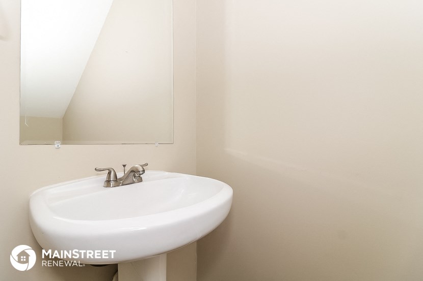 a small bathroom with a sink and a mirror