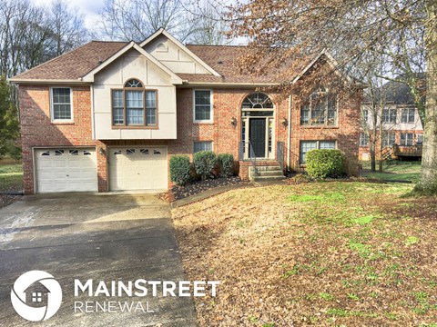 a house with a driveway and a garage door