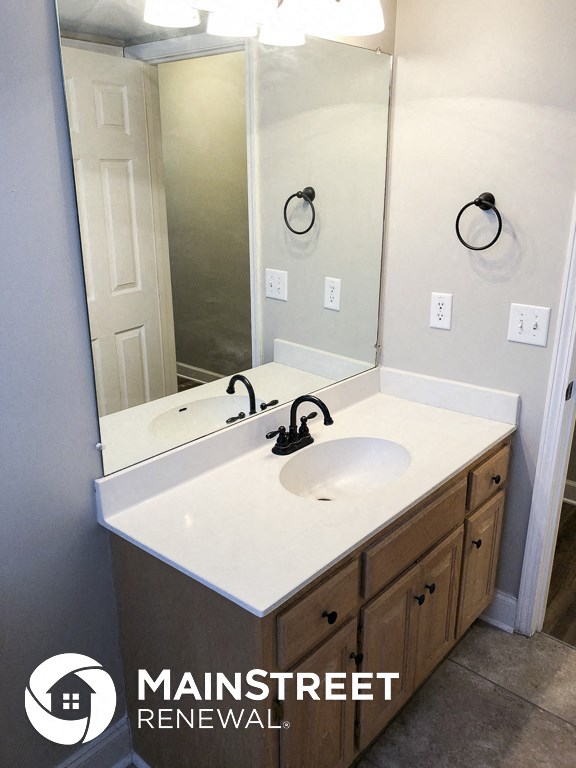a bathroom with a white sink and a mirror