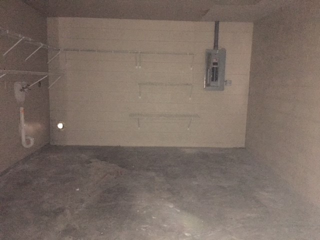 a room with a white wall and a shower in it