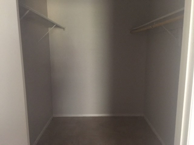 a empty closet with two empty shelves in it