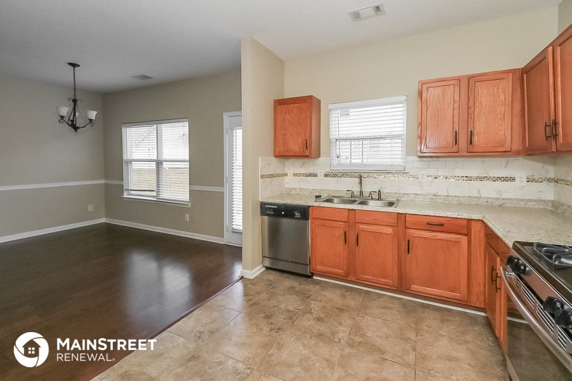 a kitchen with wooden cabinets and stainless steel appliances