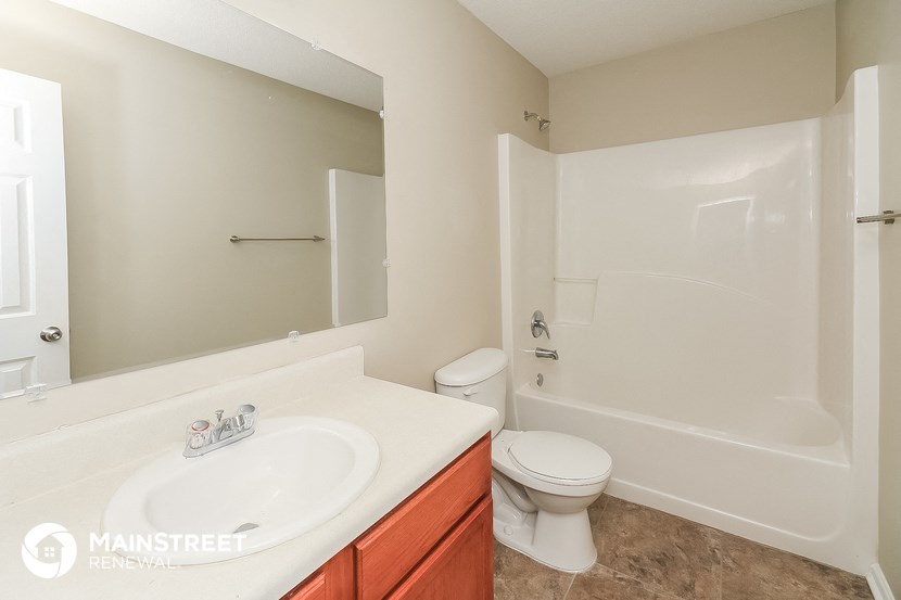 a bathroom with a sink and a toilet and a shower