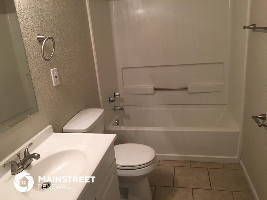 a bathroom with a toilet sink and a bath tub