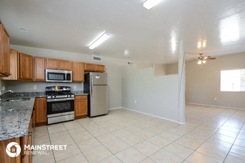 a kitchen with wooden cabinets and stainless steel appliances