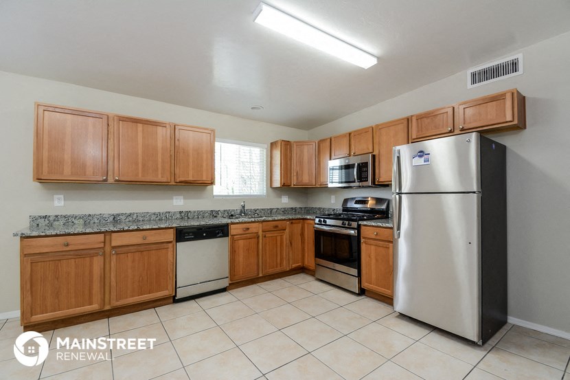 a kitchen with wooden cabinets and stainless steel appliances