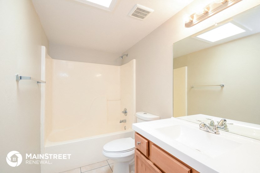 a bathroom with a sink and a toilet and a shower