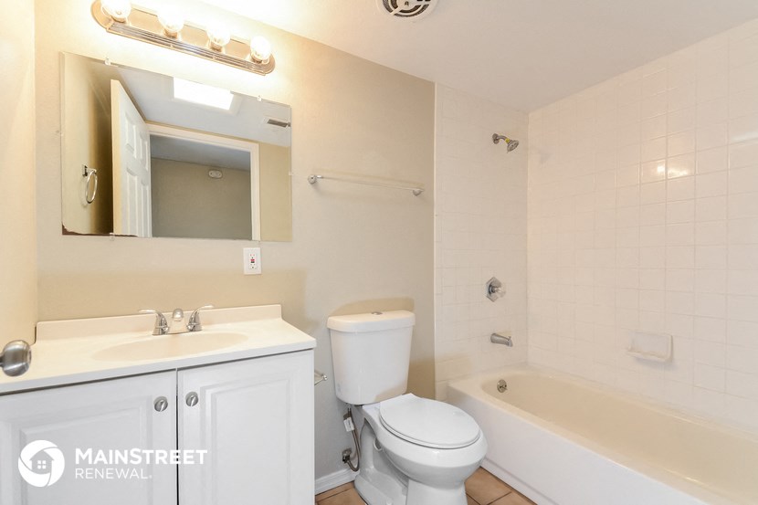 a bathroom with a sink toilet and a bath tub