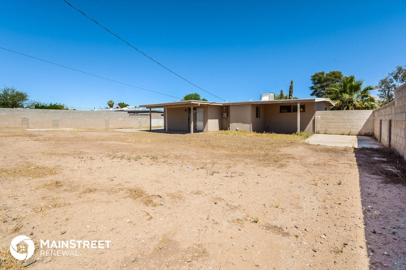 a small house with a dirt road in front of it