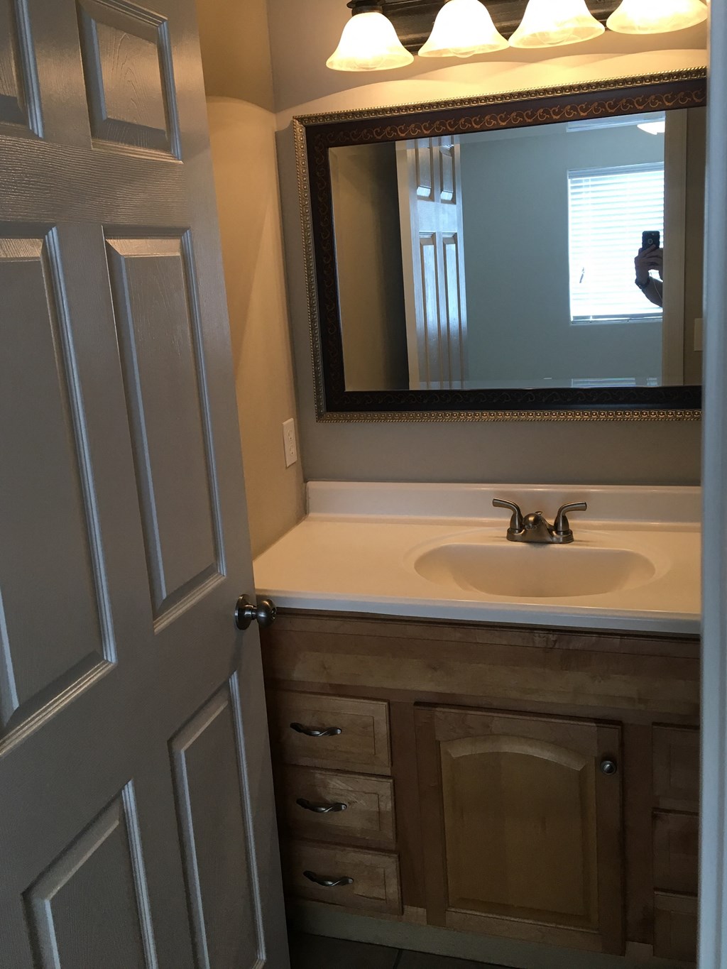 a small bathroom with a sink and a mirror