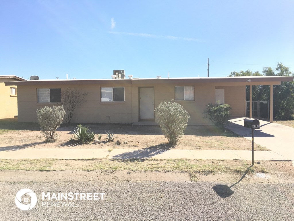 a small house with a street sign in front of it