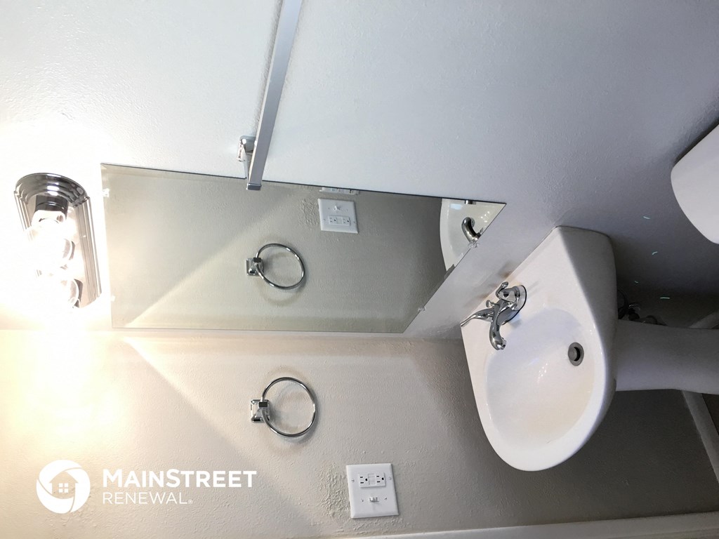 a small bathroom with a sink and a mirror