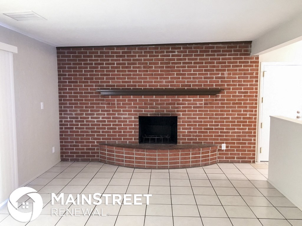 a fireplace with a brick wall in a living room