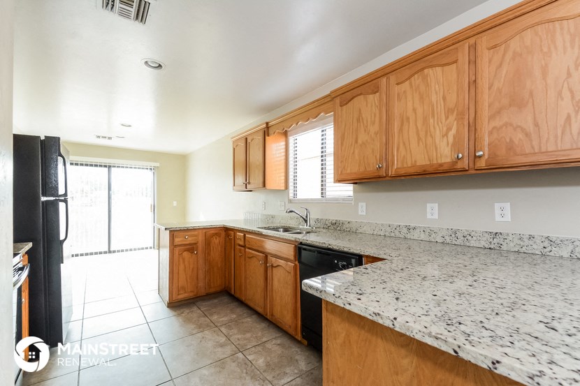 a kitchen with marble counter tops and wooden cabinets