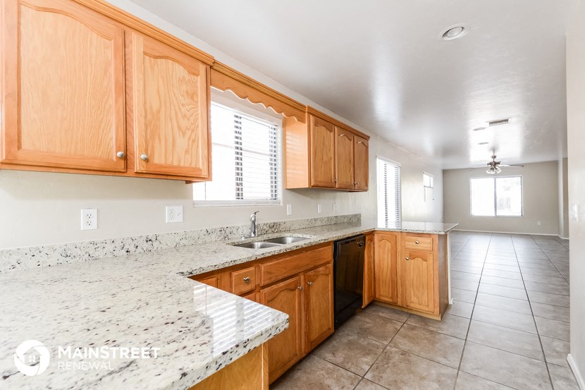 a kitchen with wooden cabinets and granite counter tops