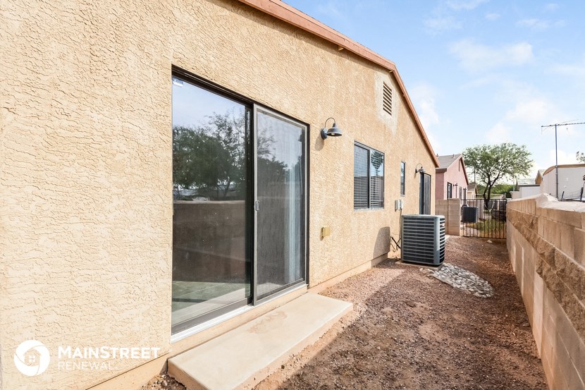 the outside of a brick house with a large sliding glass door