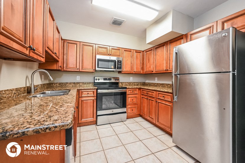 a kitchen with wooden cabinets and stainless steel appliances
