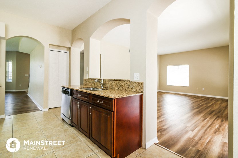 a kitchen with a wooden floor and a counter top