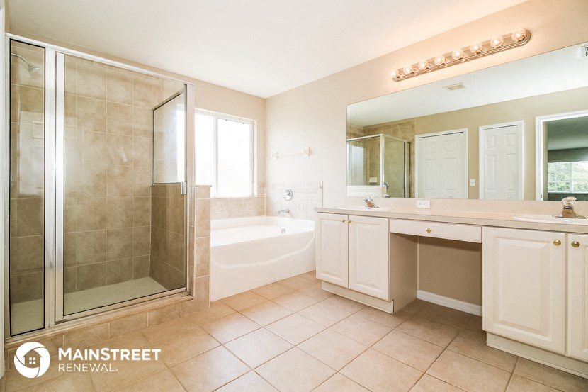 a bathroom with a shower and a sink and a bath tub