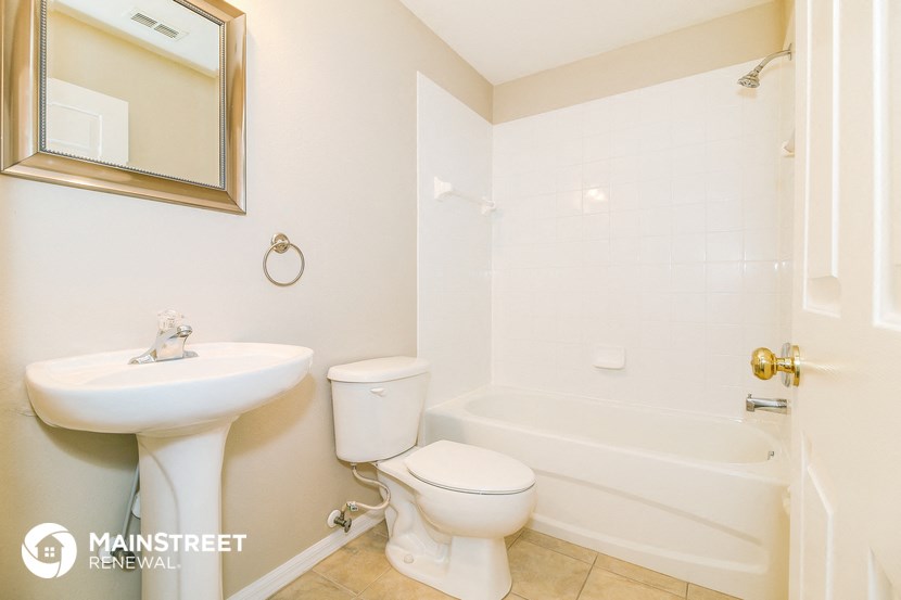 a bathroom with a sink toilet and a bath tub