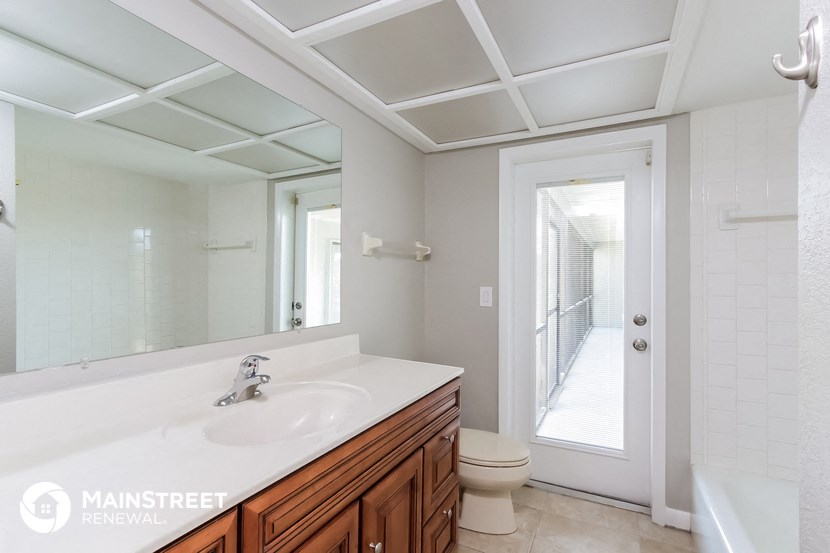 a bathroom with a sink and a toilet and a mirror