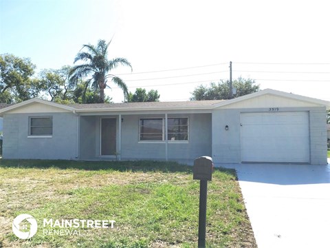 a small house with a parking meter in front of it