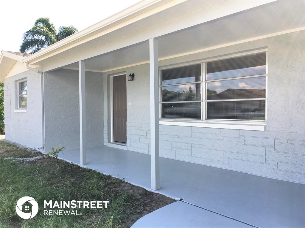the front of a house with a porch and a door