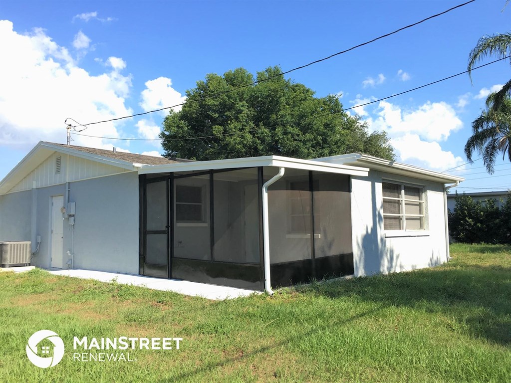 a small house with a covered porch and a screened in porch