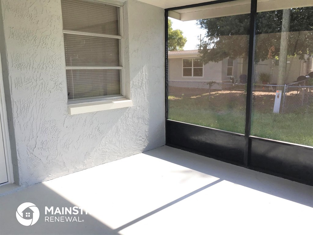 a patio with a glass door and a window