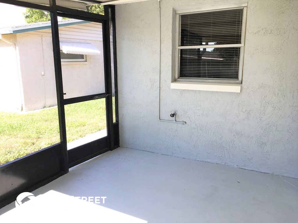 a room with a glass door and a window