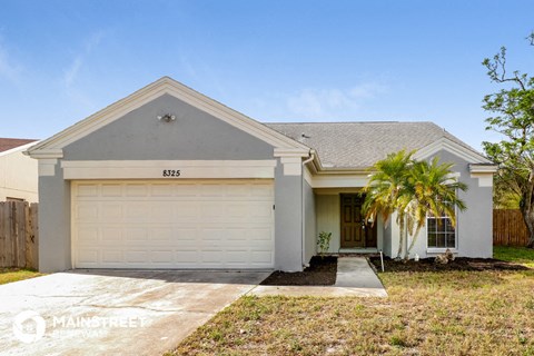 a house with a palm tree in front of it