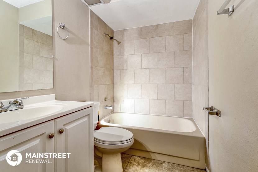 a bathroom with a toilet sink and a bath tub