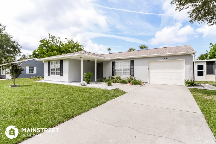 a white house with a driveway and a garage door