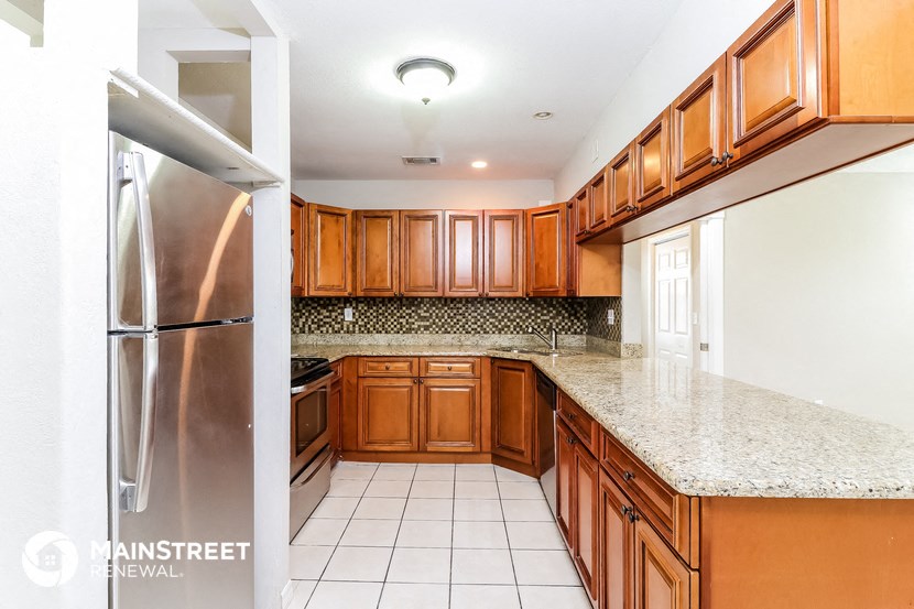 a kitchen with wooden cabinets and a counter top