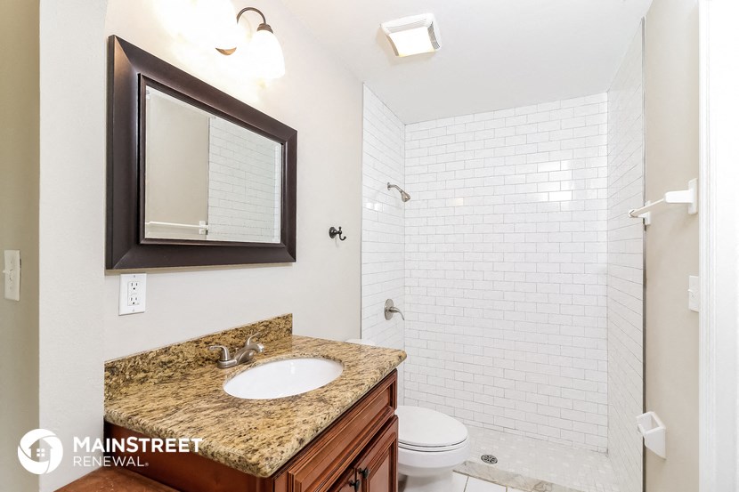 a bathroom with a sink and a toilet and a shower