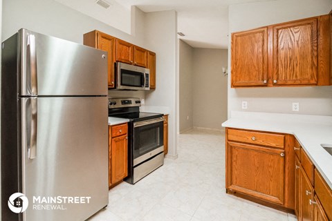 a kitchen with stainless steel appliances and wooden cabinets