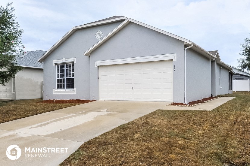 a gray house with a white garage door