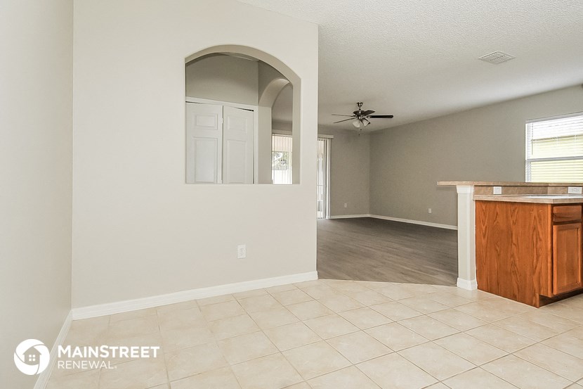the kitchen and living room of a remodeled house with an open floor plan