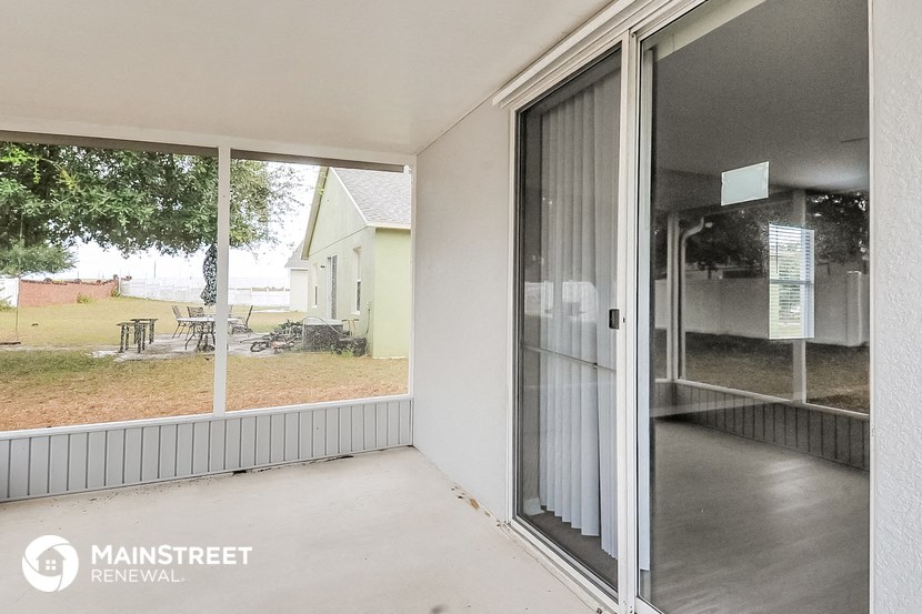 the patio on the back of the house has a sliding glass door
