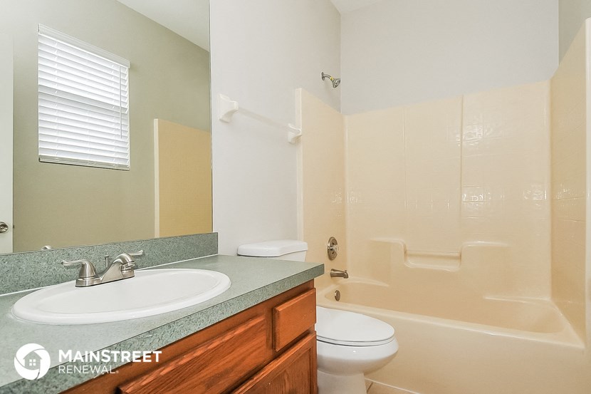 a bathroom with a sink and a toilet and a shower
