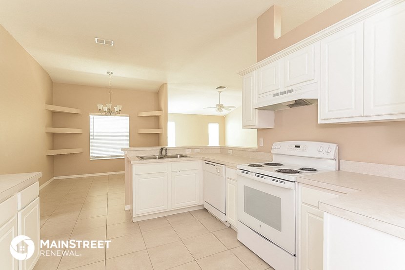a white kitchen with white appliances and white cabinets