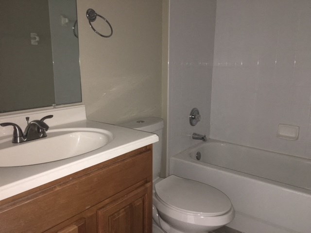 a bathroom with a sink toilet and a bath tub
