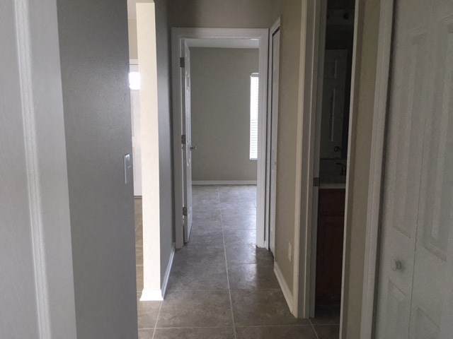a view of the hallway from the kitchen into the living room