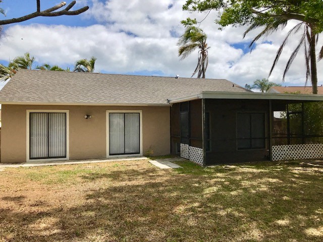 a house with two garage doors and a yard