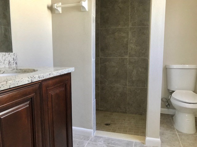 a bathroom with a toilet and a sink and a shower