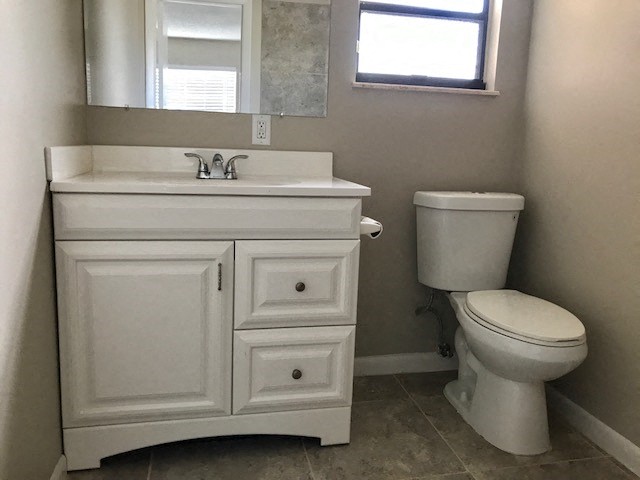 a bathroom with a toilet and a sink and a mirror