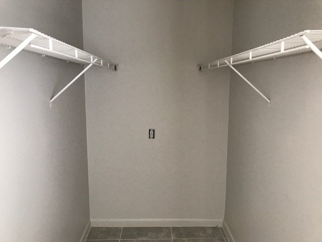 an empty closet with two empty shelves in it