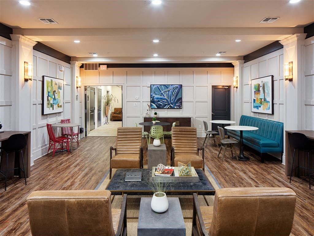 a large lobby with chairs and tables and a couch