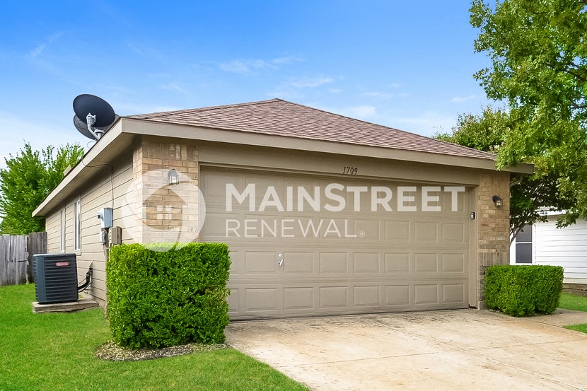 a garage door with the name of man street renewal on it